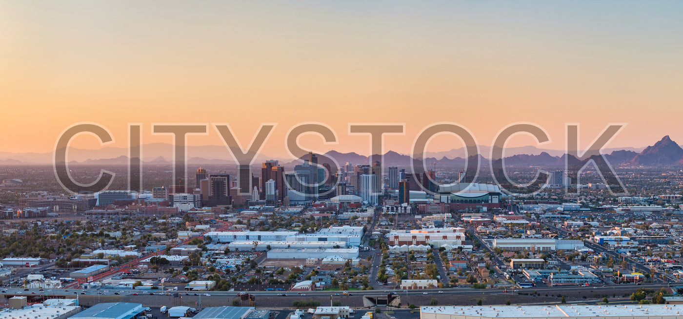 Phoenix city skyline and distant mountains at sunset