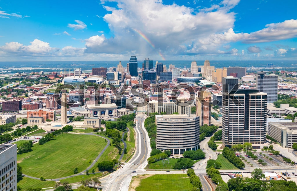 Aerial view of Kansas City skyline with rainbow and blue sky