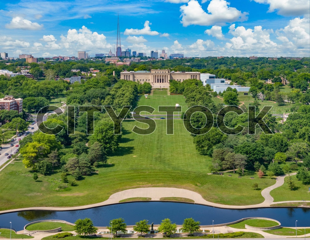 Aerial view of a lush green park with a vibrant urban skyline in Kansas City