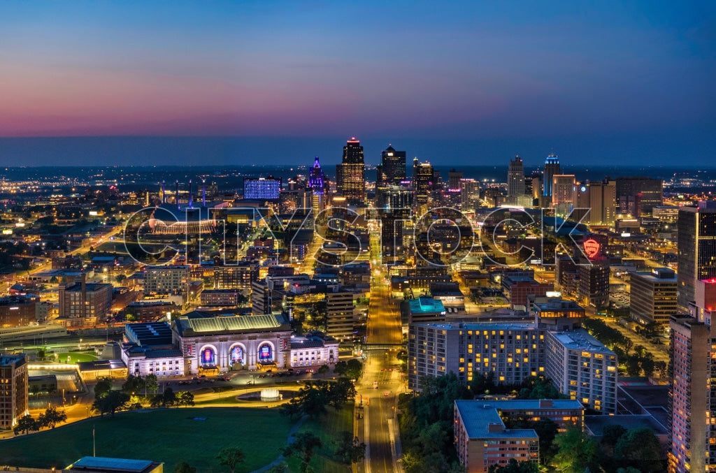 Aerial view of Kansas City skyline during sunset, highlighting vibrant hues.