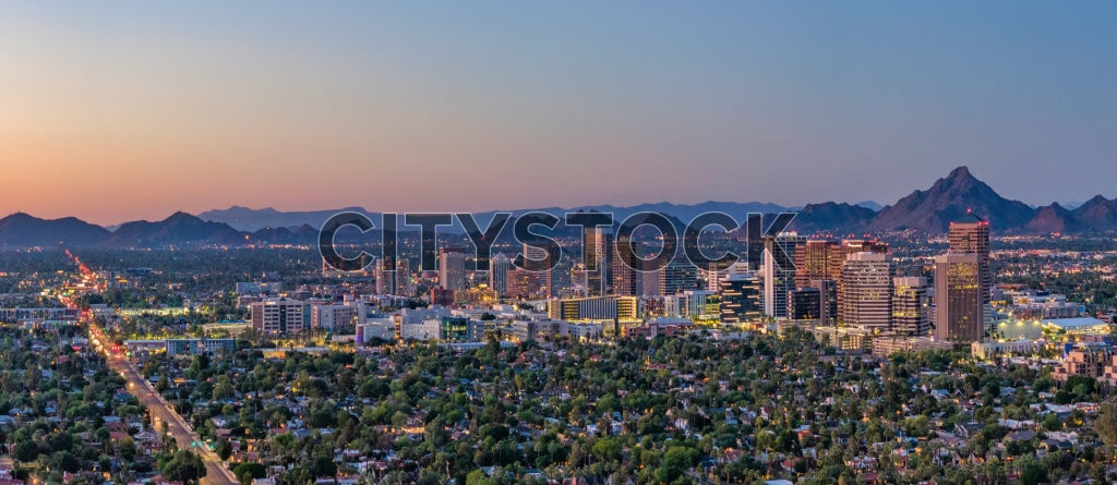 Aerial view of Phoenix skyline at sunset with mountain scenery