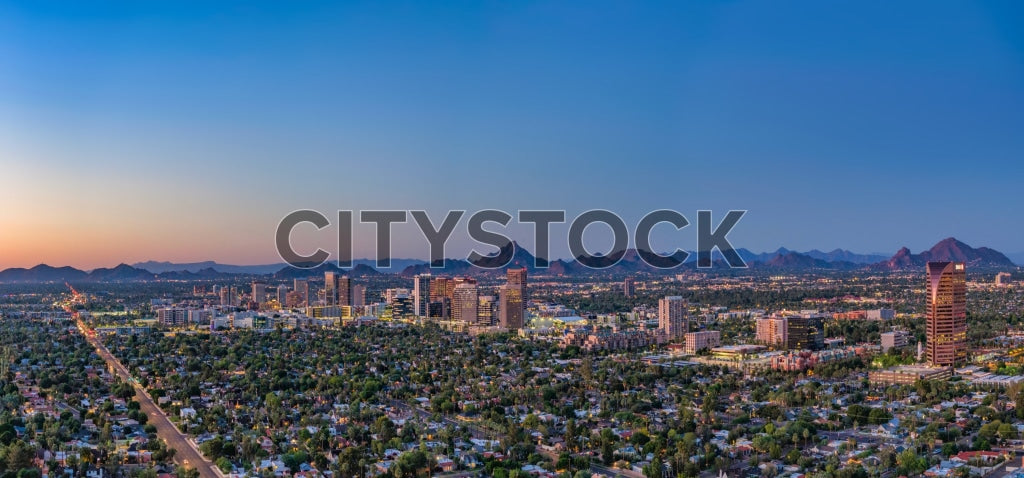 Aerial view of Phoenix at sunset showing cityscape and mountains