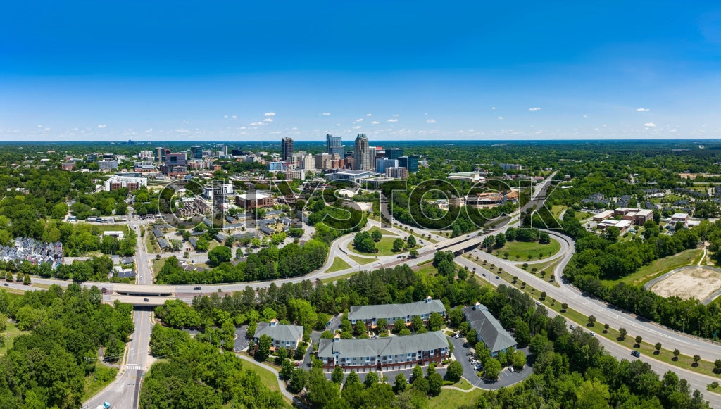 Aerial cityscape of Raleigh, NC with downtown view and green areas