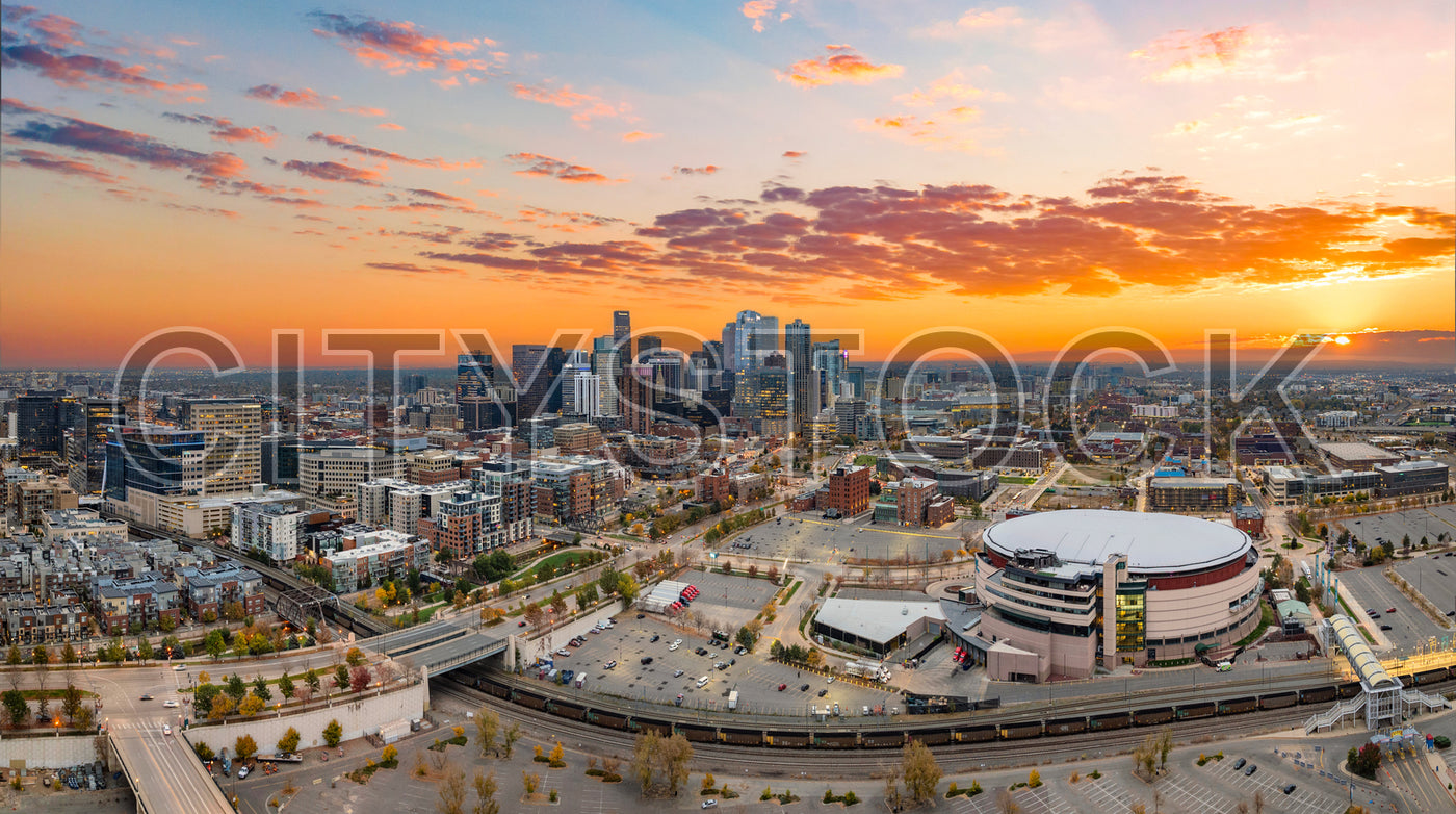 Panoramic view of Denver skyline at sunset with vibrant skies