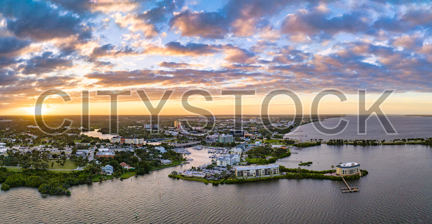 Aerial view of Melbourne, FL at sunset highlighting the waterfront and urban areas
