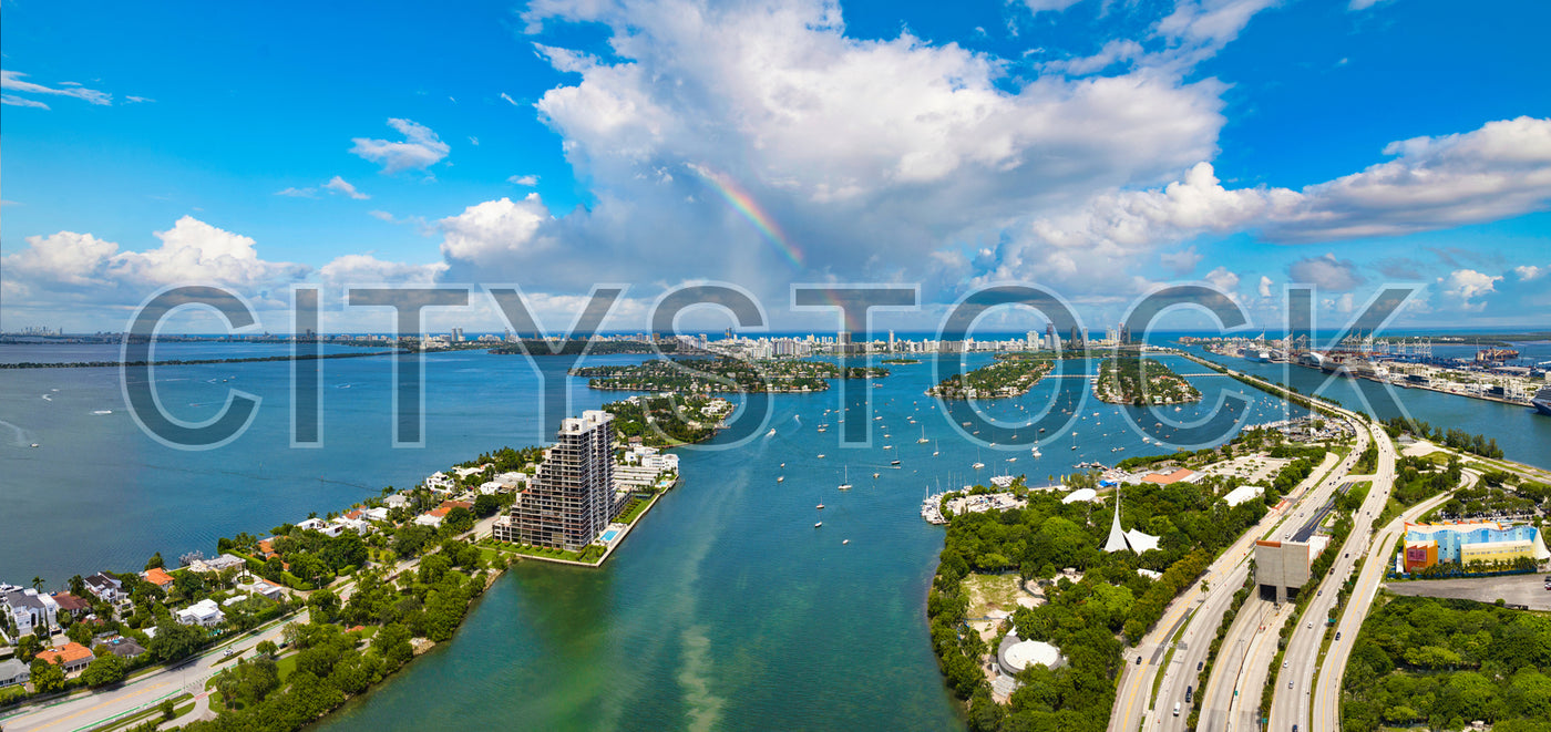 Aerial view of Miami skyline with waterfront and rainbow