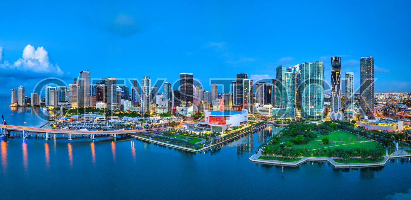 Miami skyline with sunset and water reflections panorama
