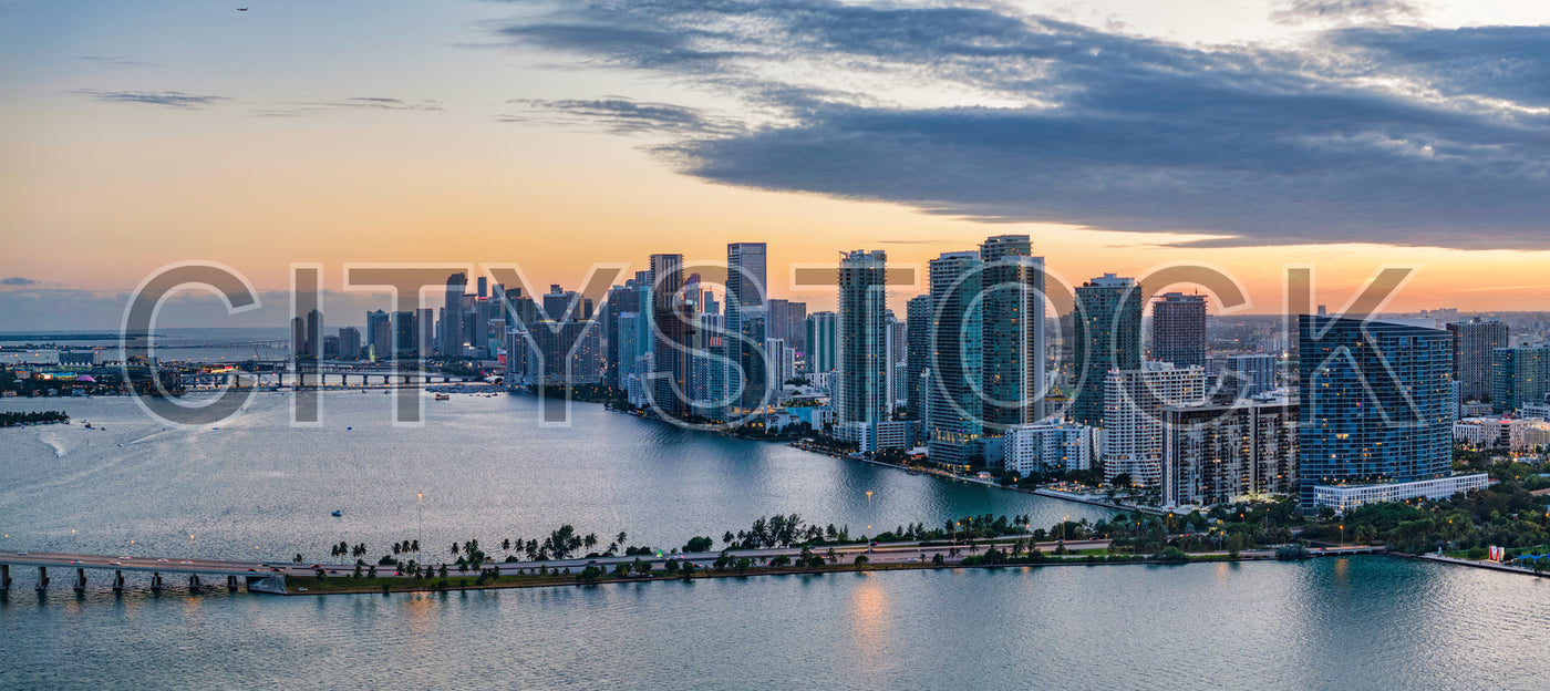 Miami skyline featuring reflective bay waters and sunset backdrop