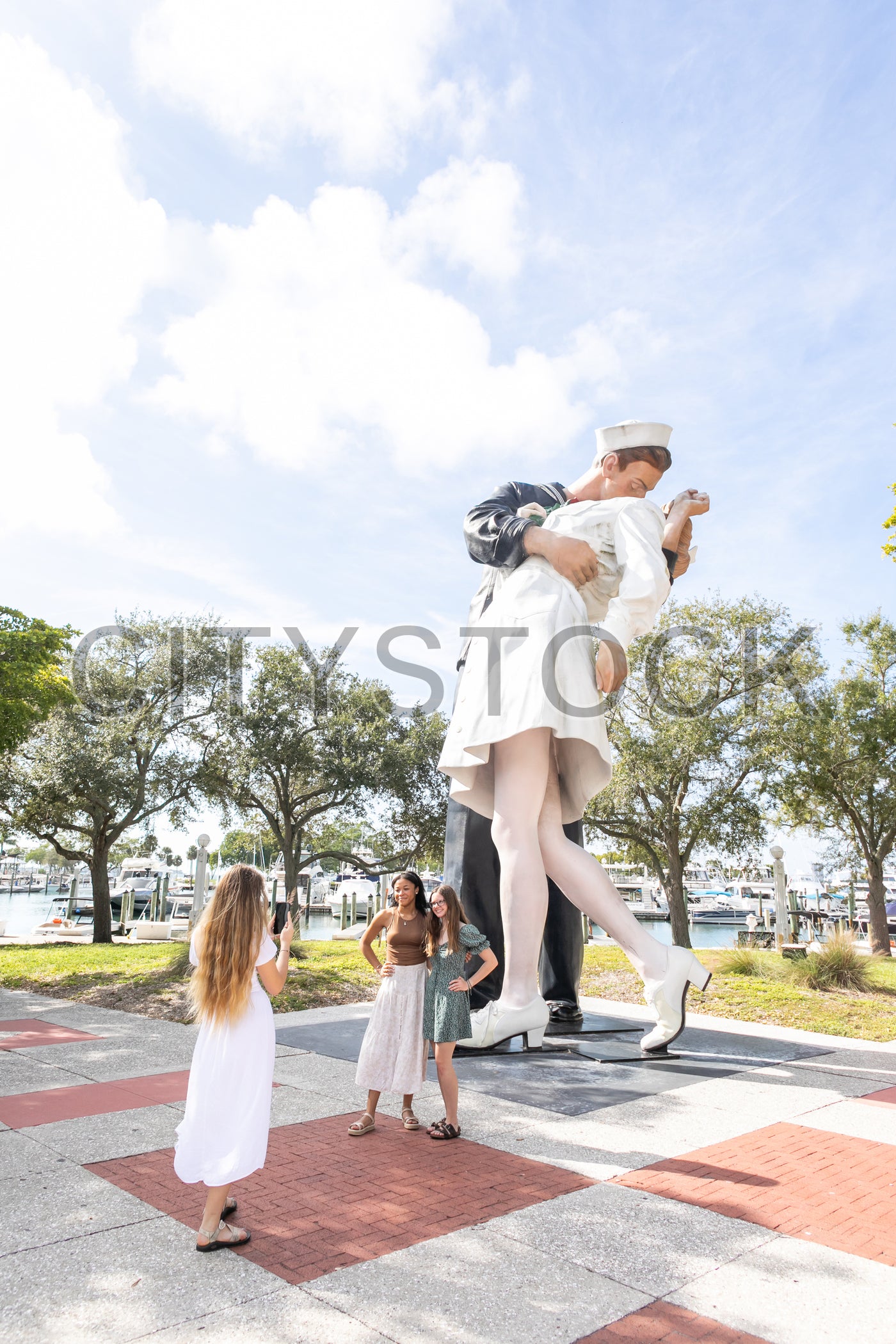 Tourists capturing moments at iconic Sarasota WWII statue