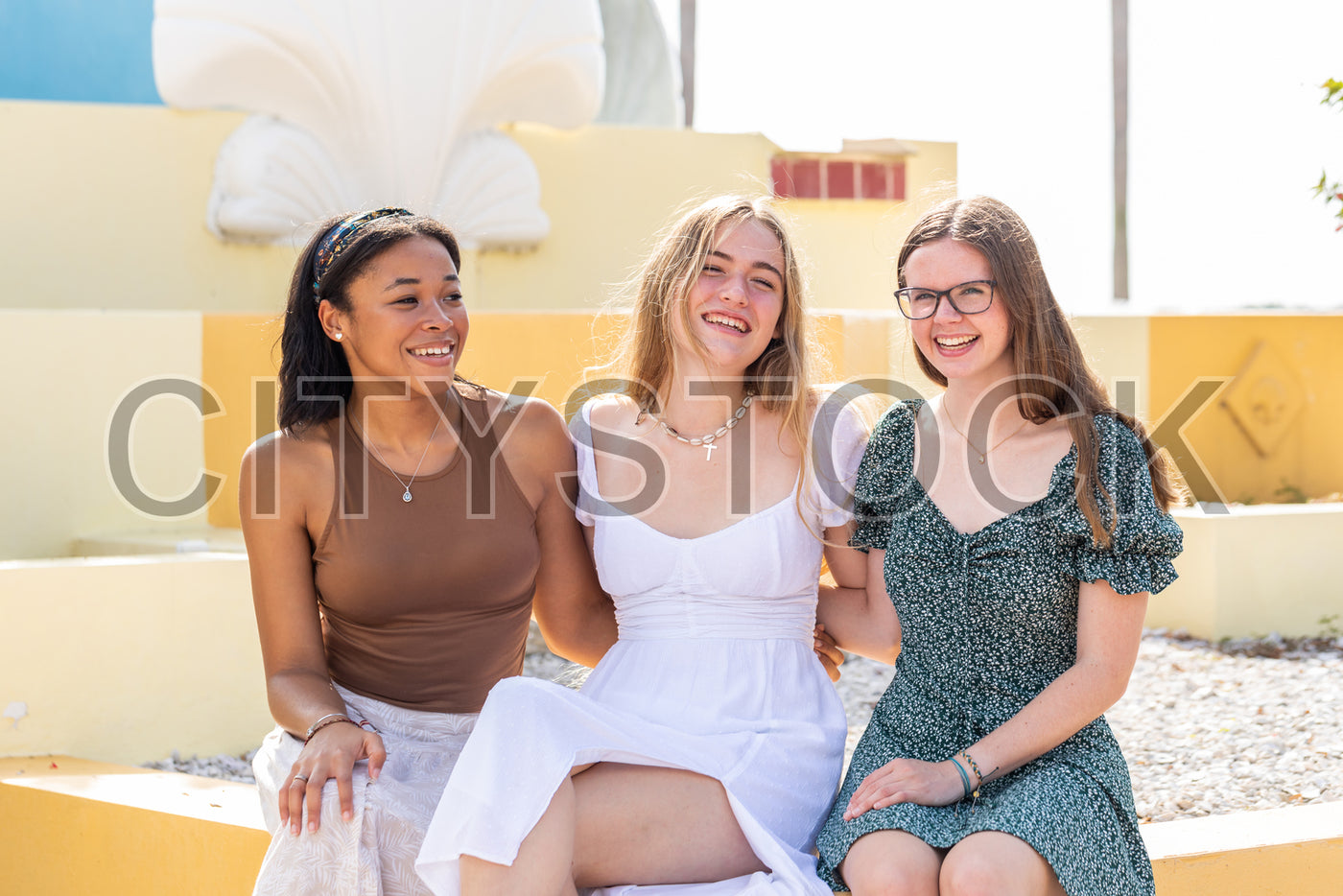 Three diverse young women laughing together in Sarasota park