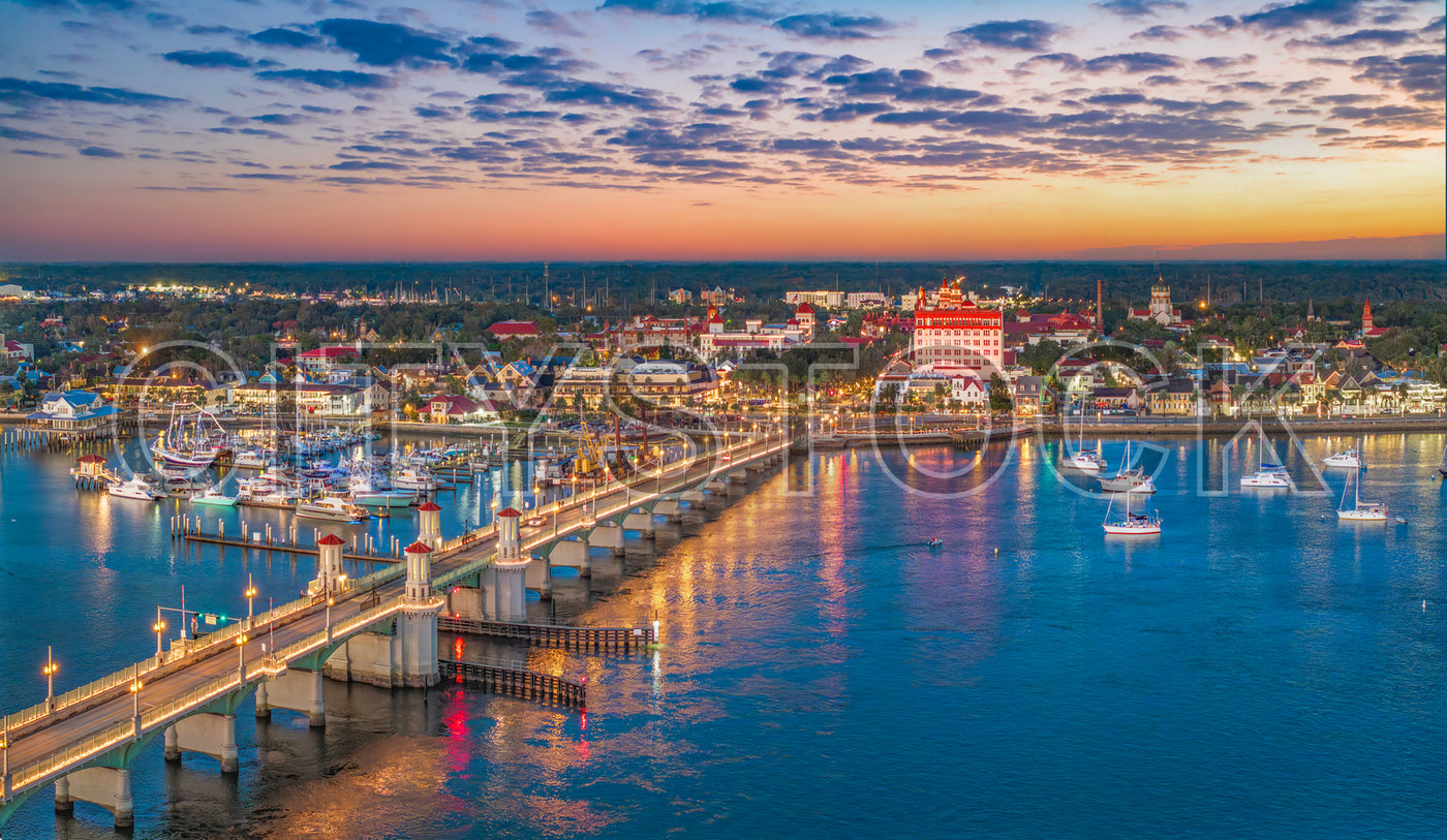 Twilight view over St. Augustine Marina with lit bridge and boats