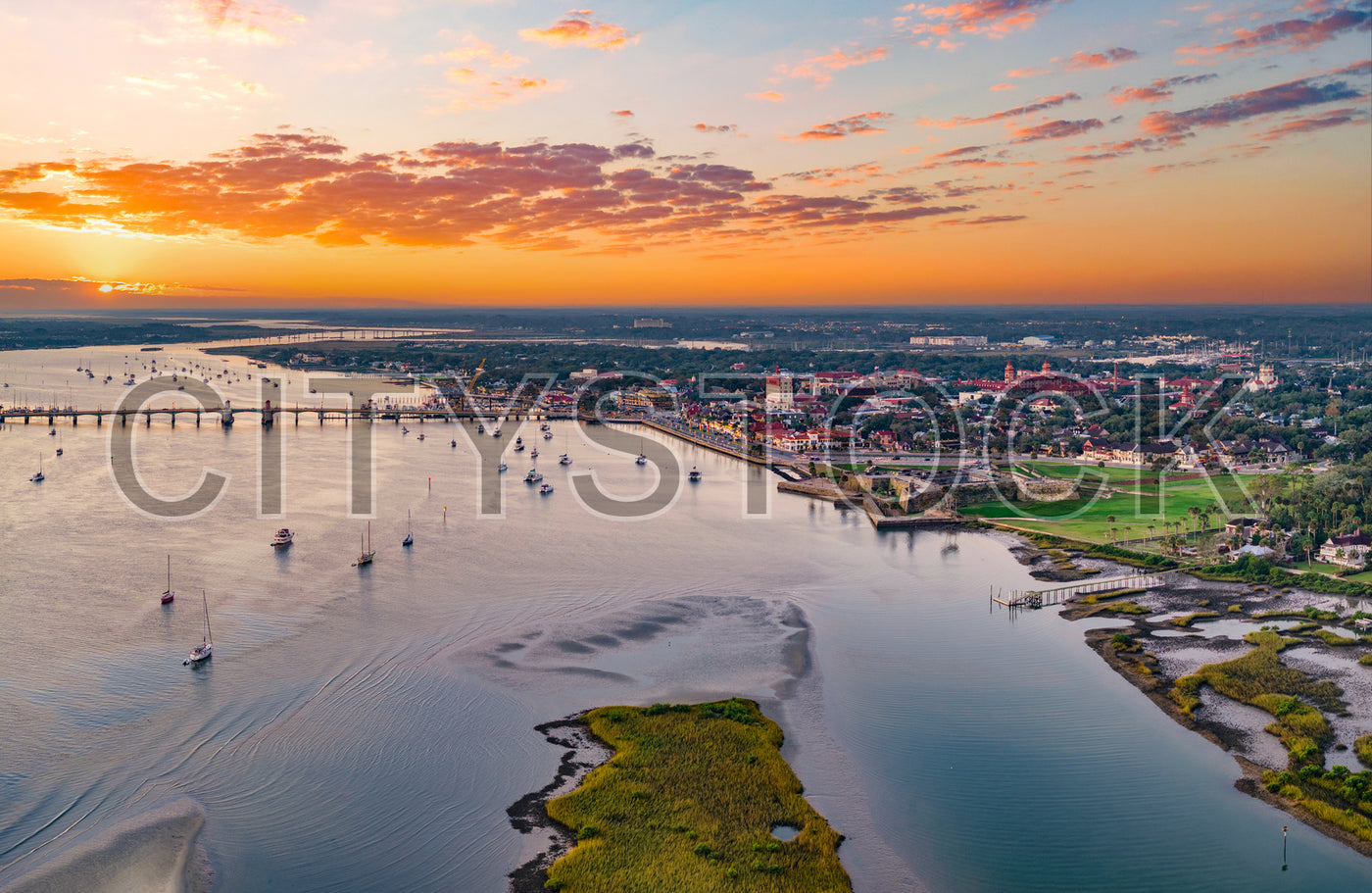 Aerial view of St. Augustine marina and cityscape at sunset