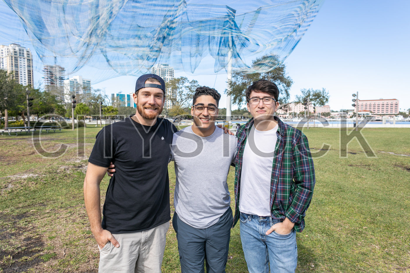 Group of friends in a park with St Petersburg, Florida skyline behind