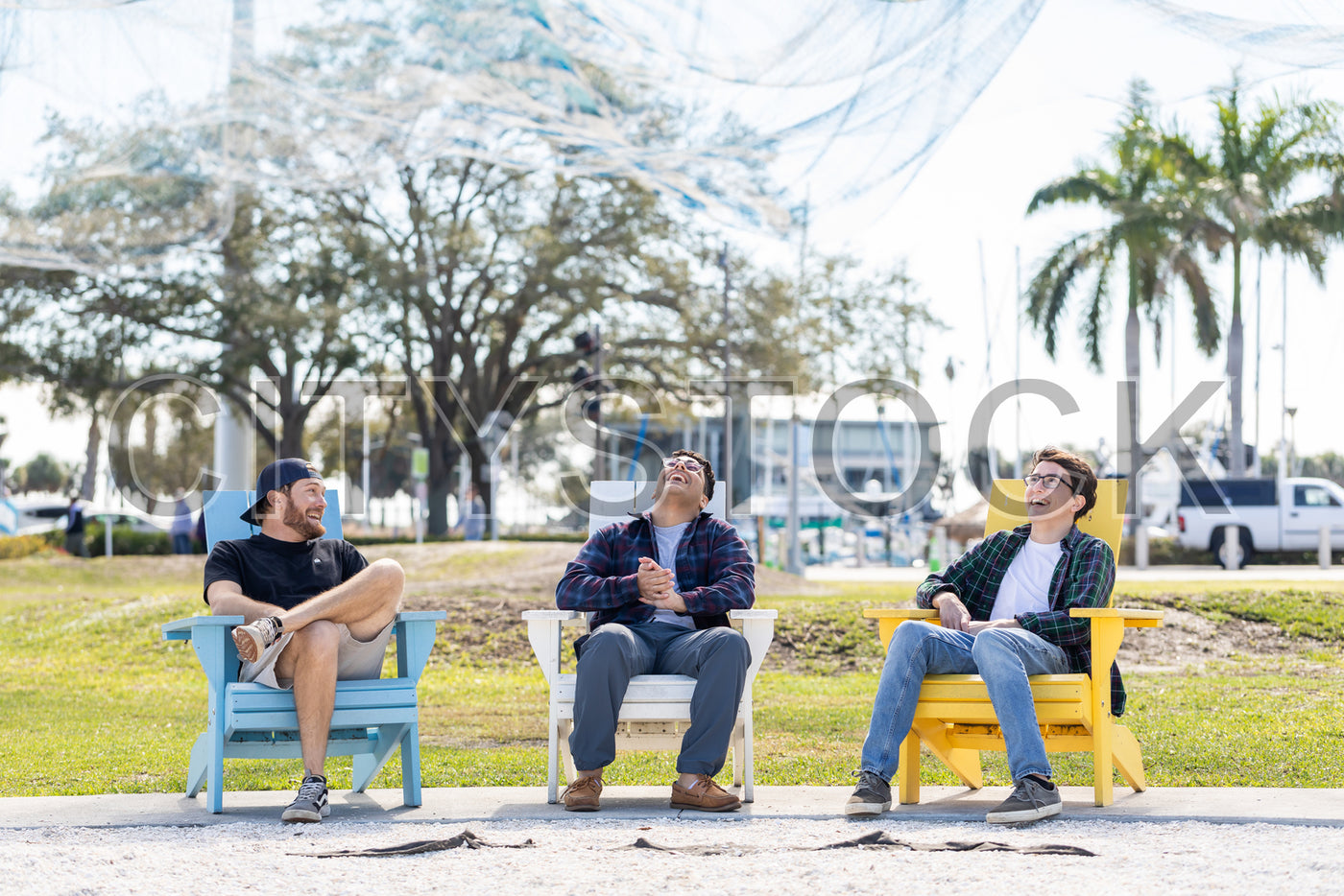 Three friends laughing joyfully outdoors in St Petersburg