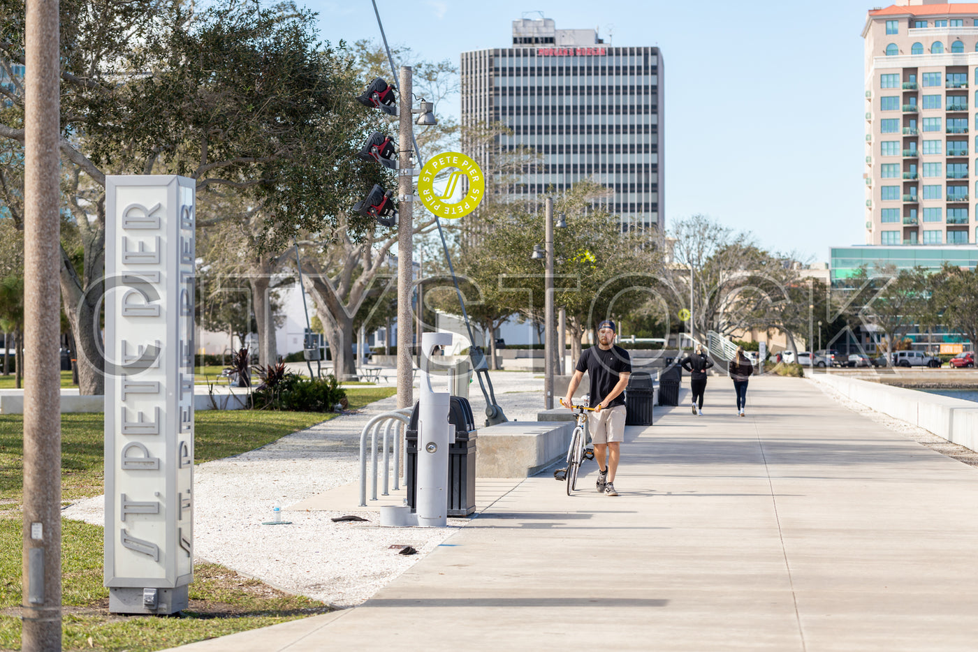 Urban scene at St. Petersburg Pier, cyclist, sunny day