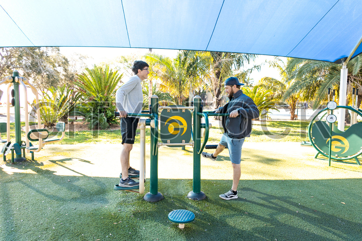 Two men exercising at outdoor park gym in St Petersburg, Florida