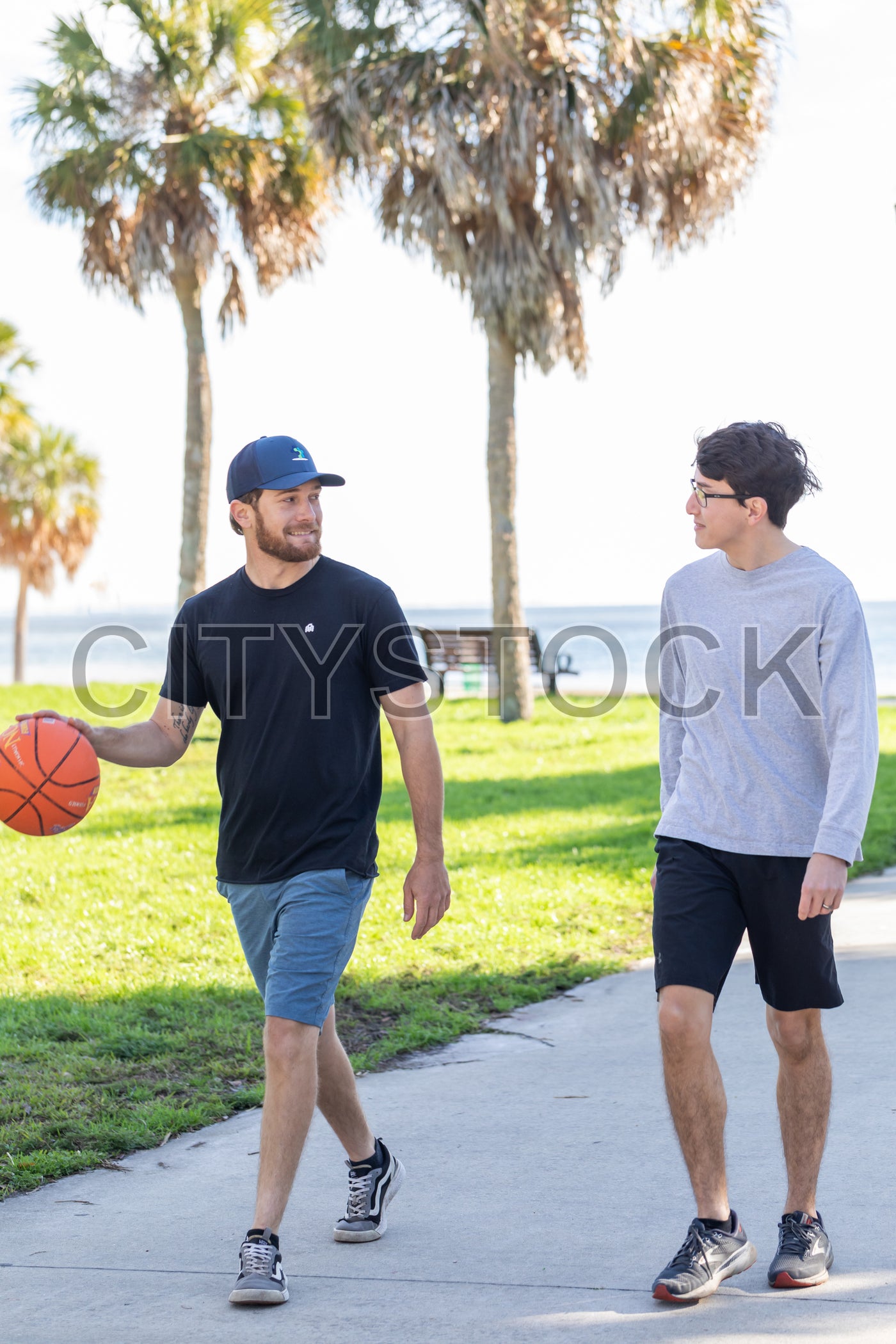 Two men playing basketball in sunny St Petersburg park