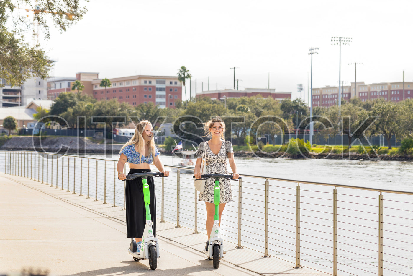 Young Women Enjoying Electric Scooter Ride in Tampa