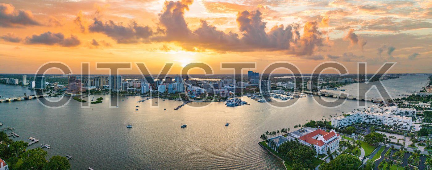 Aerial view of West Palm Beach skyline at sunset with boats