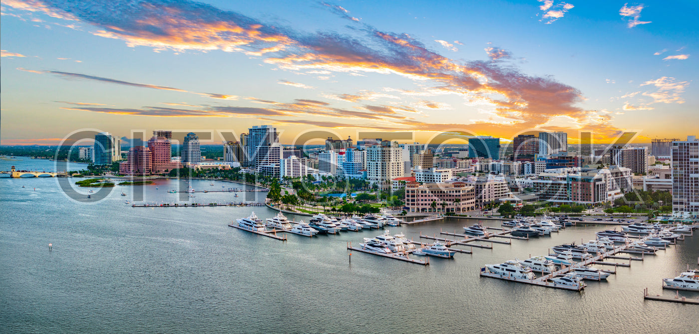 Sunset view of marina and urban skyline in West Palm Beach, Florida