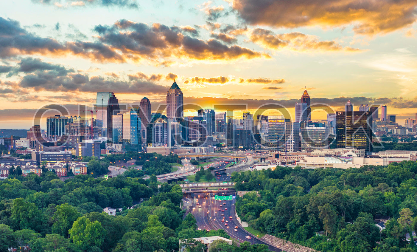 Panoramic shot of Atlanta's skyline at sunset, highlighting vibrant city lights.