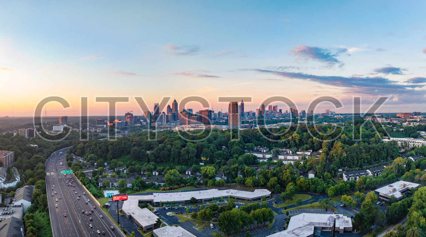 Atlanta's skyline at sunset with busy highway foreground