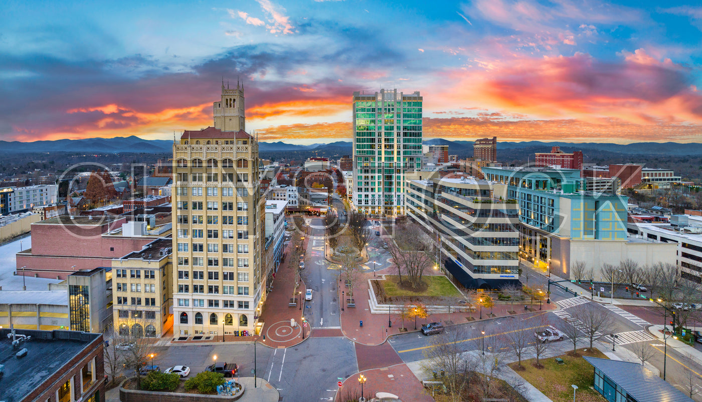 Asheville cityscape at sunset with historic and modern buildings