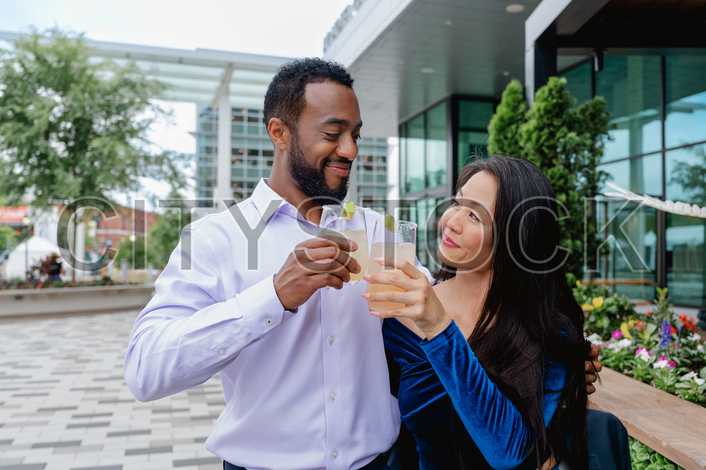 Young couple sharing a laugh over drinks in Greenville SC