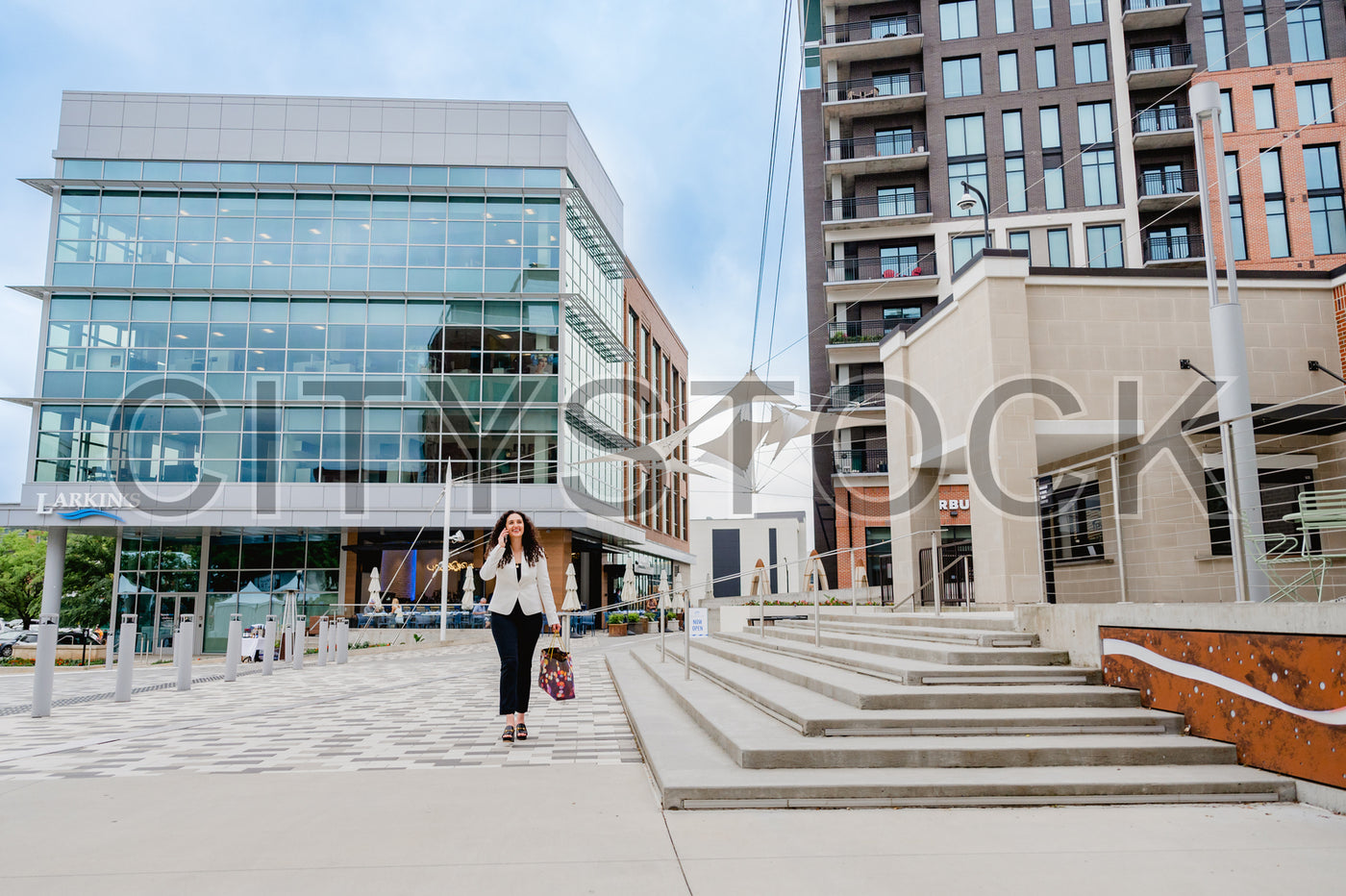 Young woman walking in modern city environment, Greenville