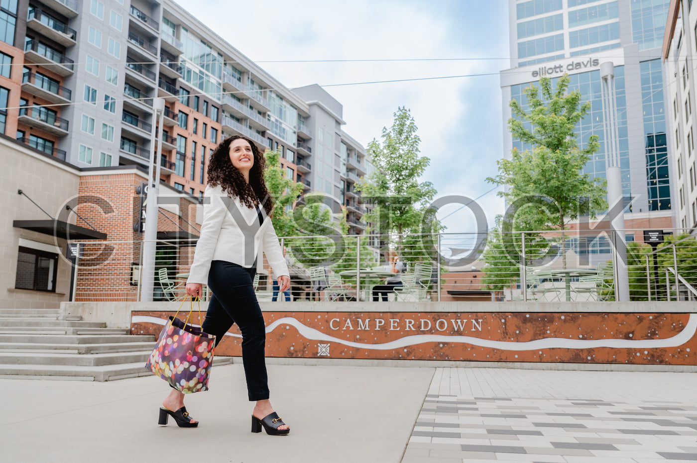 Young woman in modern fashion walks cheerfully in Greenville