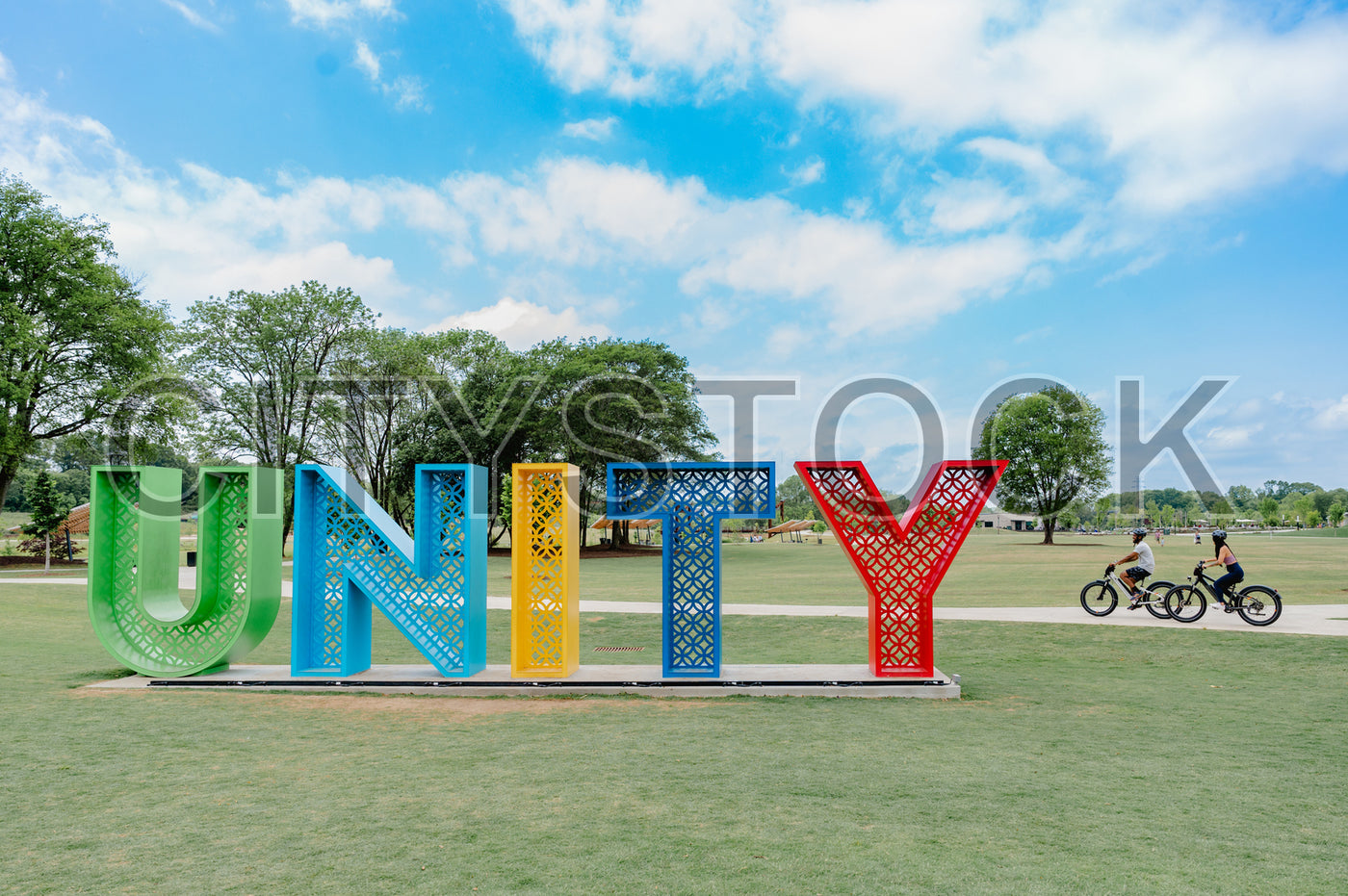 Colorful Unity Sculpture in Greenville Park with Cyclists