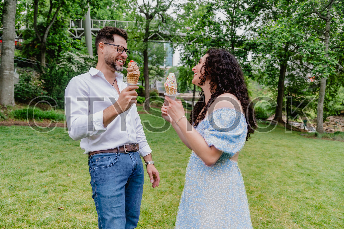 Couple laughing with ice cream in Greenville park