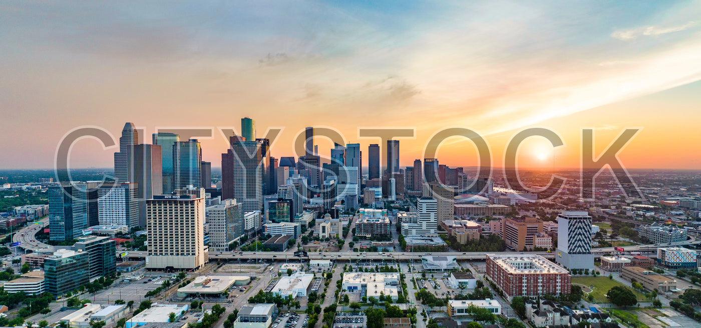 Aerial view of Houston skyline at sunset with golden hues