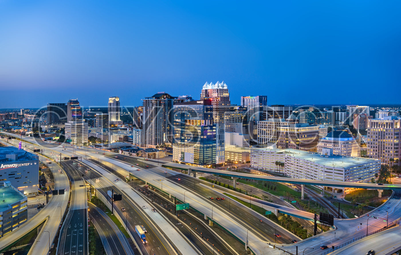 Orlando city skyline with bright light trails on highways at twilight