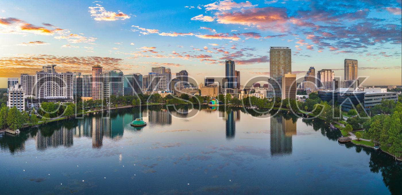 Early morning Orlando cityscape with vibrant sunrise reflections