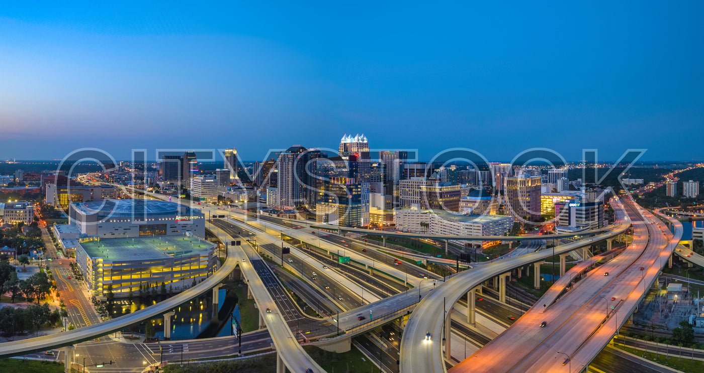 Orlando skyline at dusk featuring Amway Center and illuminated roads