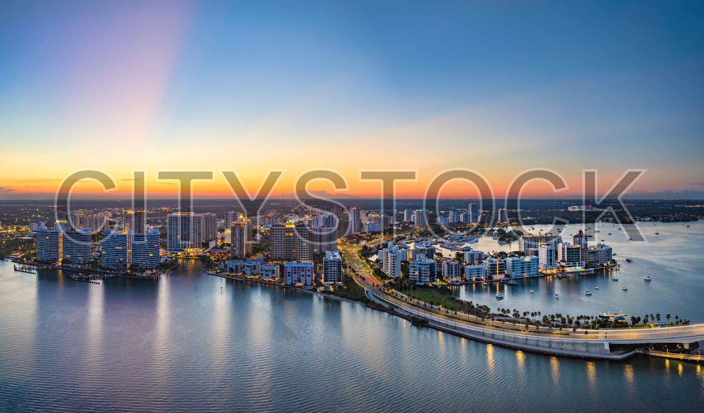 Aerial sunset view of Sarasota's skyline with high-rises beside the bay