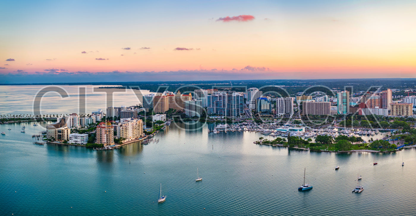 Aerial sunset view of Sarasota Bay, Florida with yachts and urban skyline