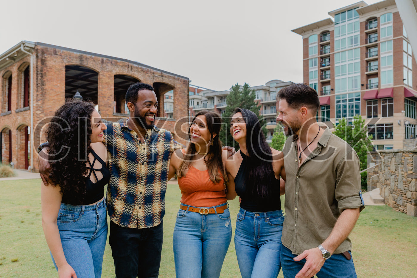 Group of diverse friends laughing in Greenville park