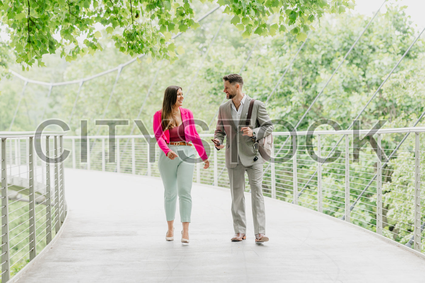 Two professionals walking and talking in Greenville park, SC