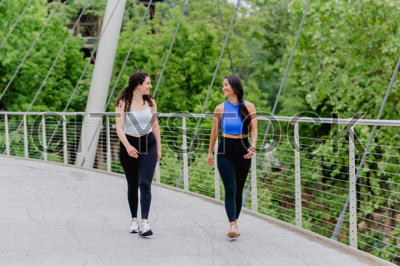 Active Women Jogging on Greenville Modern Bridge