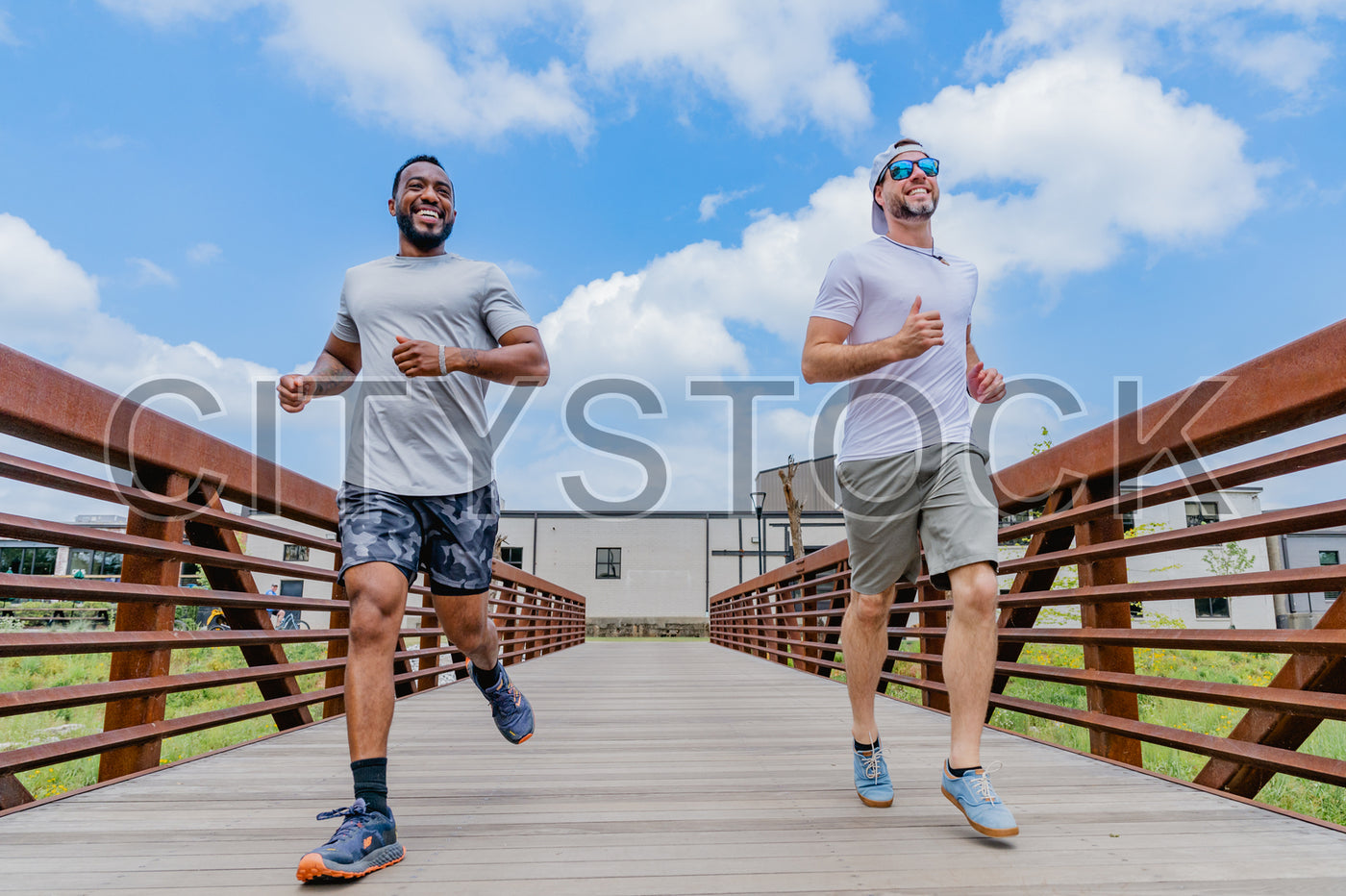 Two Happy Men Jogging on a Bridge in Greenville, SC