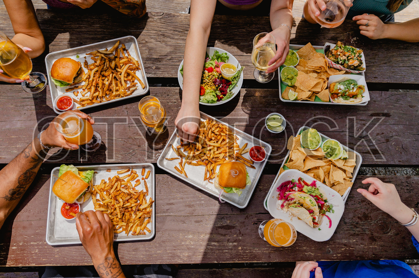 Group of friends enjoying a meal together outdoors in Greenville