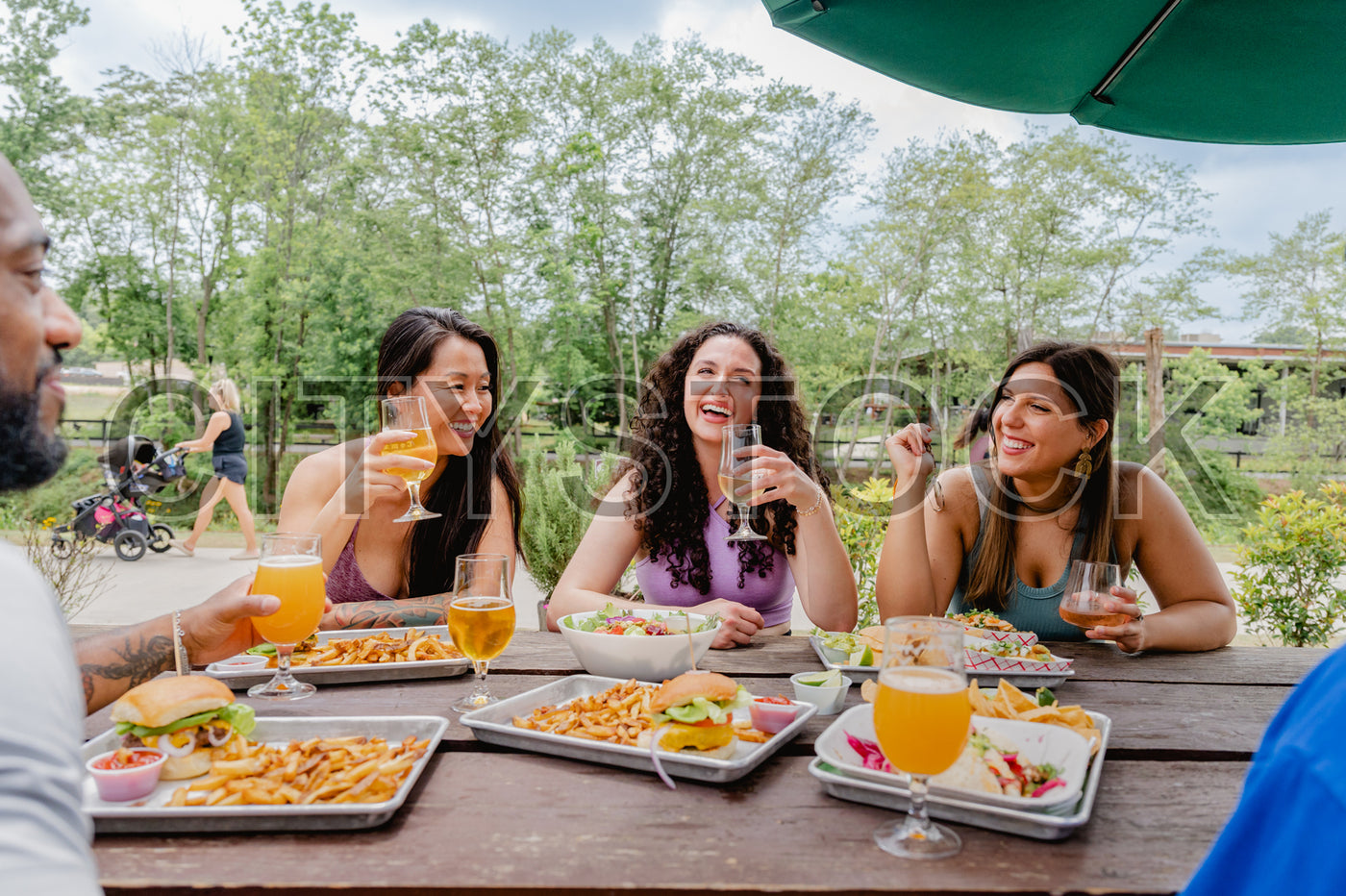 Diverse group of women enjoying lunch outdoors in Greenville
