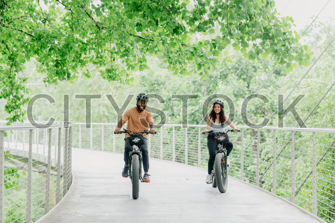Man and woman enjoying a bike ride in a green park in Greenville, SC