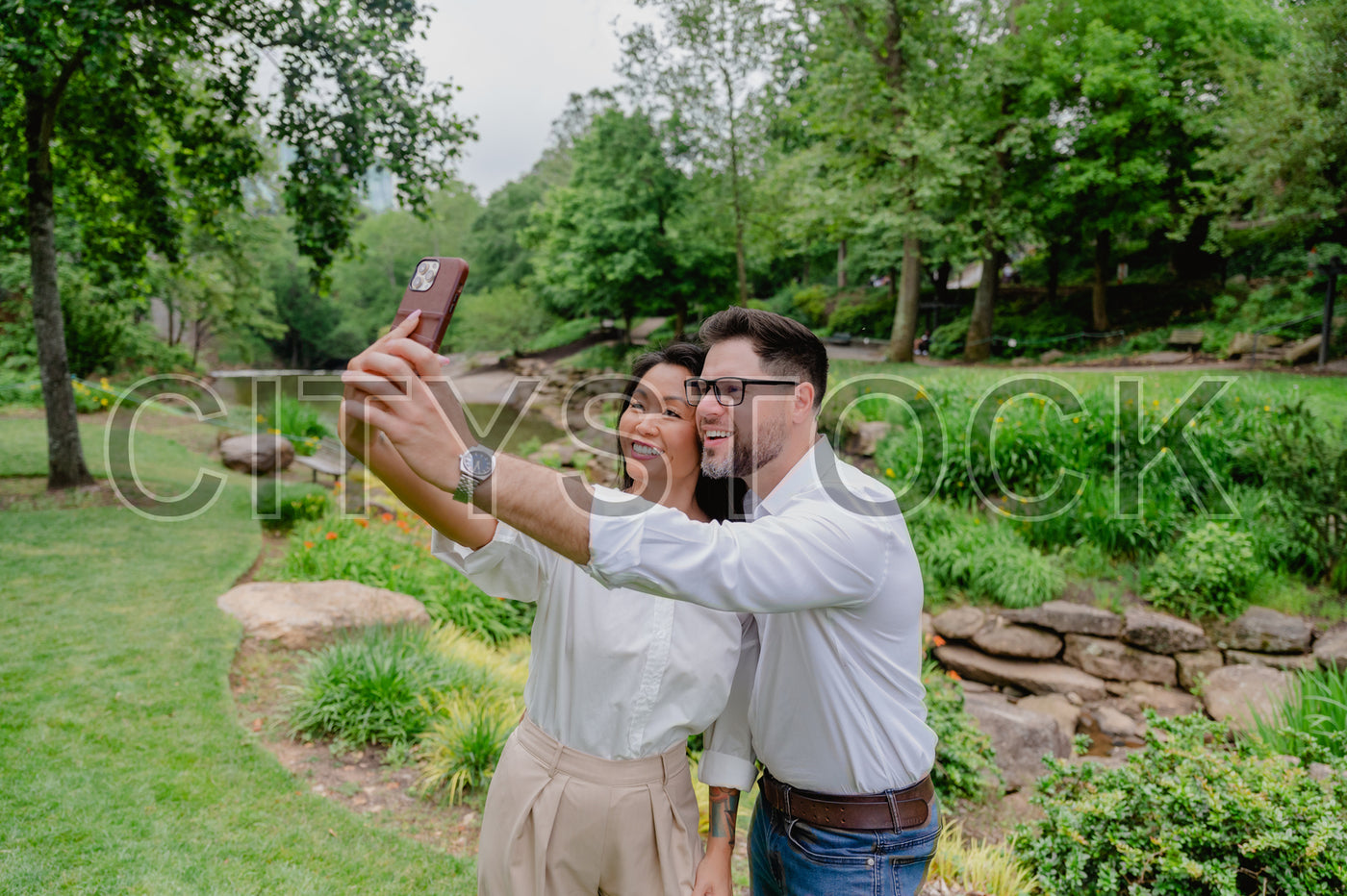 Young couple enjoying a fun selfie in scenic Greenville park, SC