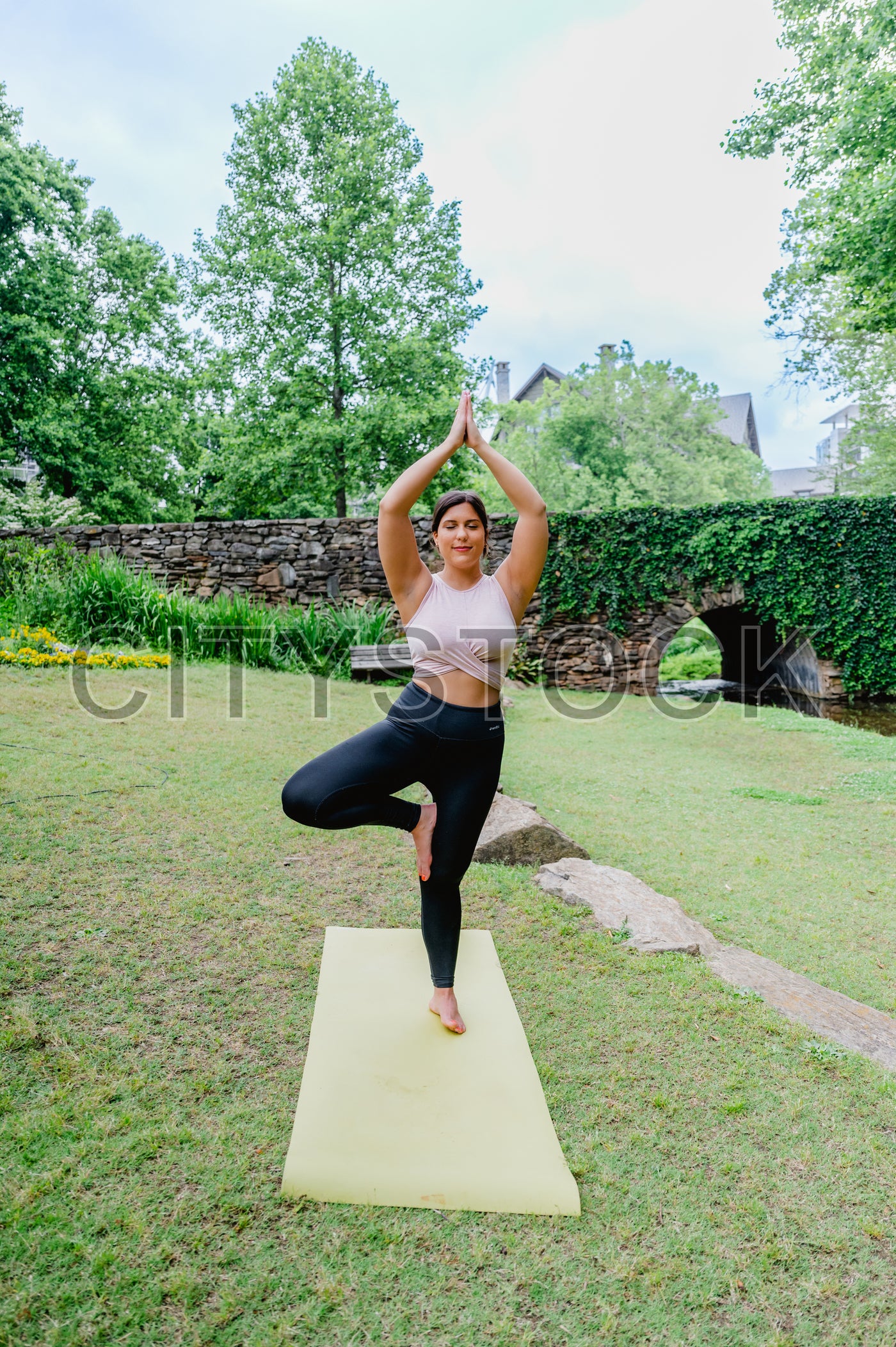 Woman practicing yoga in serene garden, Greenville, SC