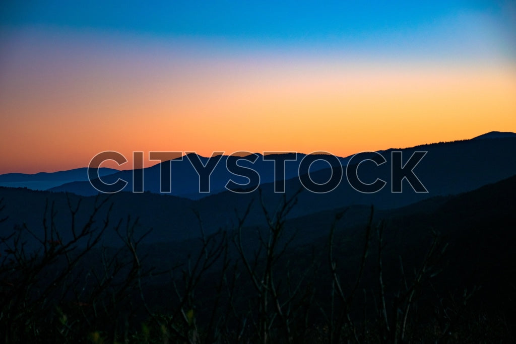 Captivating sunset over Asheville mountain ranges in rich blues and oranges