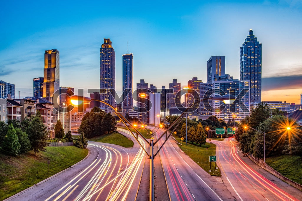 Atlanta skyline and highways lit up at sunset, showing a vibrant city