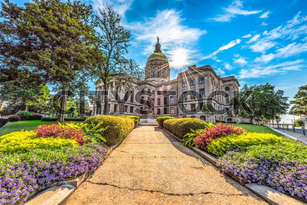 Atlanta capitol building on a sunny day with blue skies and vibrant gardens